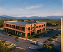 Low-rise brick commercial building with a landscaped parking lot